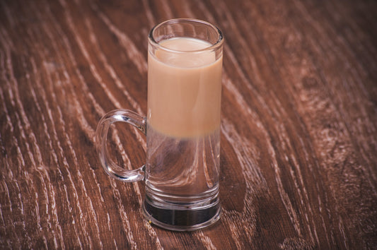 Buttery nipple shot sitting on a wooden table