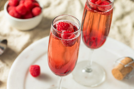 kir royale aperitif cocktails with raspberry garnish