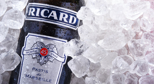 Pastis licorice alcohol bottle in crushed ice, with water vapor on the bottle